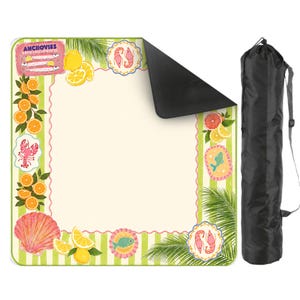 May include: A picnic blanket with a cream-colored center, green and white striped border, and decorative illustrations of seafood, citrus fruits, and palm fronds. The blanket includes a black carrying case for easy transport.