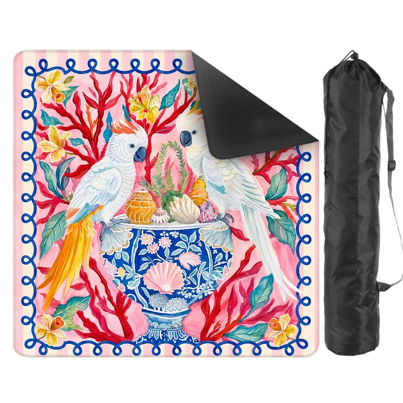 May include: A rectangular yoga mat featuring a vibrant illustration of two white cockatoos perched above a blue and white vase filled with seashells and coral. The mat has a pink background with a decorative border and comes with a black carrying bag.