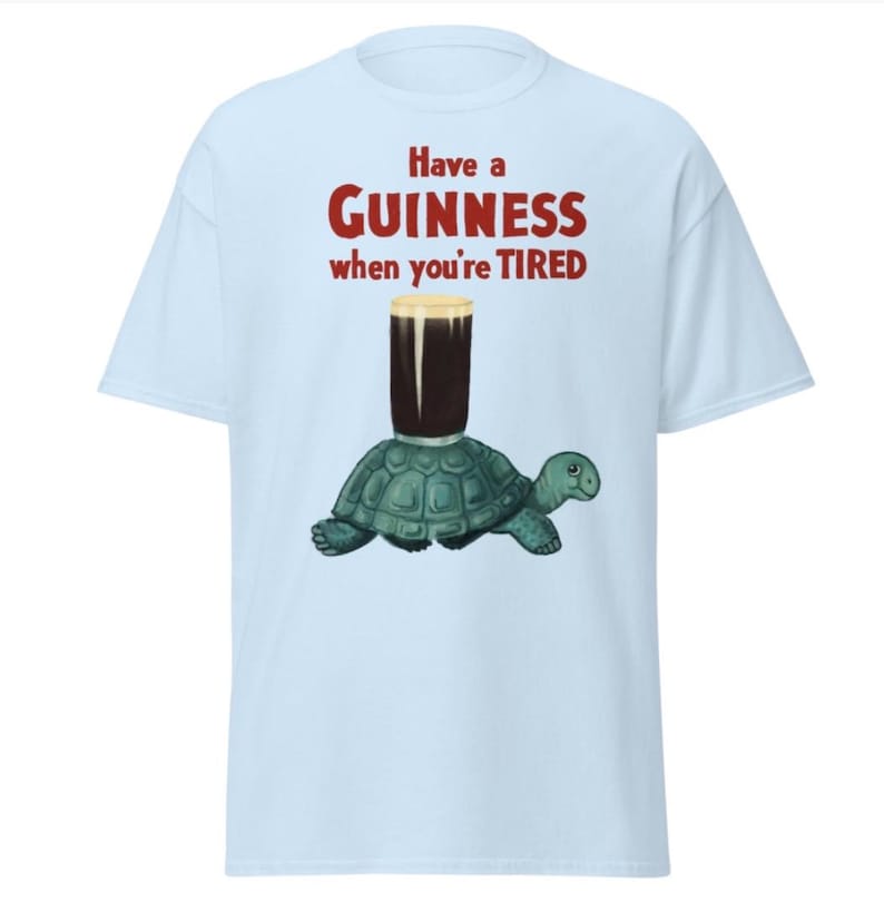 May include: A light blue t-shirt with the text "Have a GUINNESS when you're TIRED" in red. A cartoon turtle is carrying a glass of Guinness.
