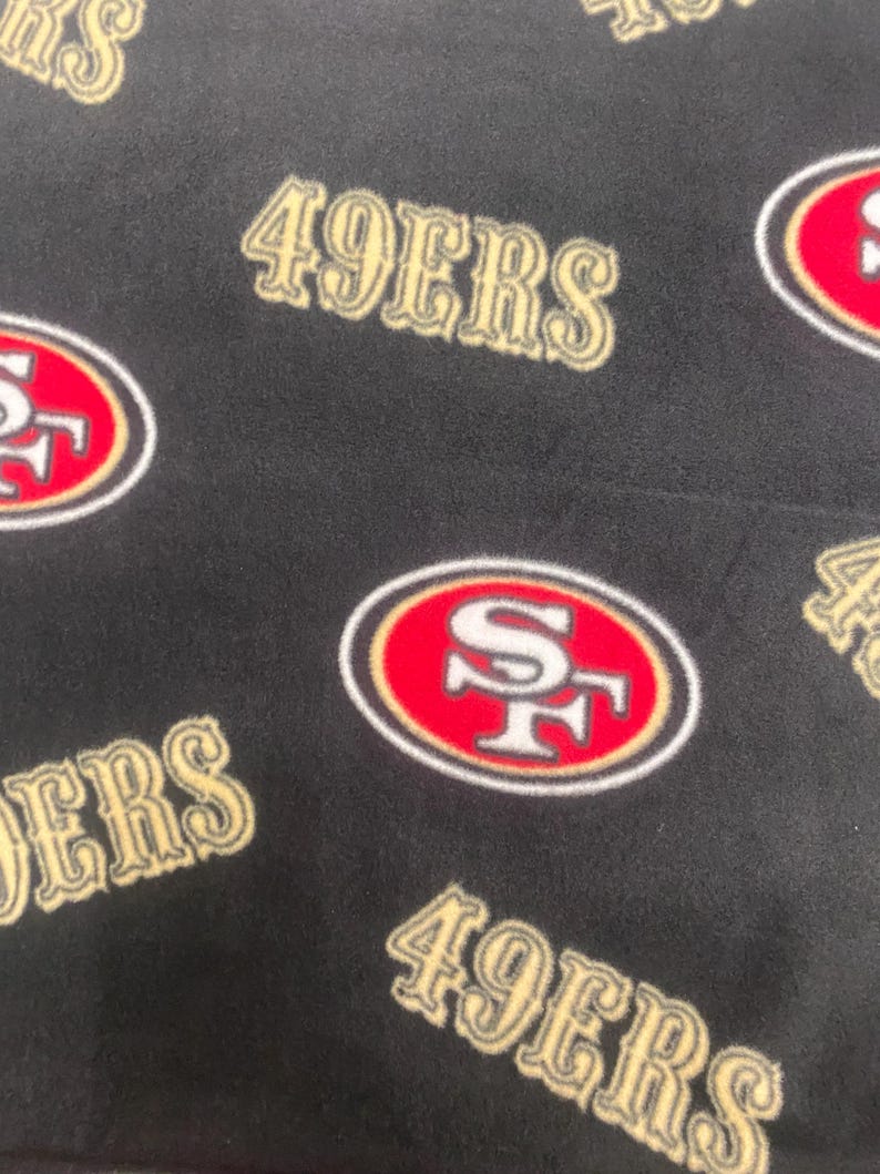 San Francisco 49ers Logos and Emblems All Over on Black With Beige 2