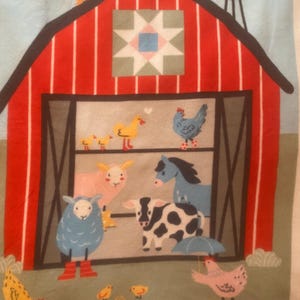 May include: A colorful farm scene featuring a red barn with a windmill and various cartoon animals. The animals include a blue sheep in red boots, a cow, a horse, chickens, and a duck. The barn has a decorative quilt square.