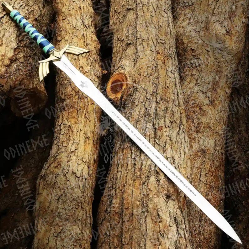 May include: A silver sword with a detailed hilt featuring gold accents and a blue and green wrapped handle. The blade has etched markings and a decorative emblem near the hilt. The sword is displayed against a textured brown background.