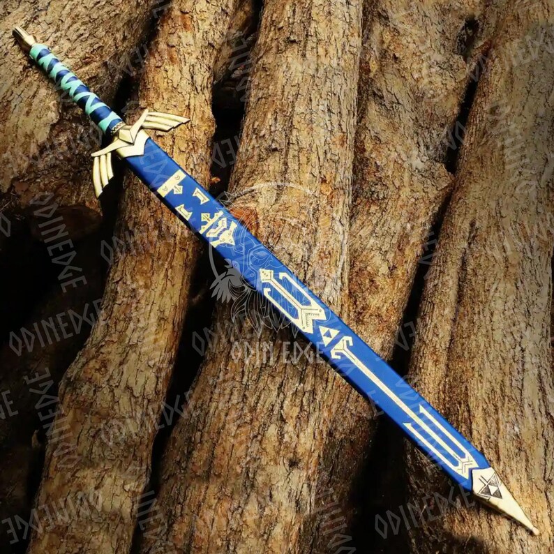 May include: A decorative sword with a blue blade and gold detailing. The hilt has wing-shaped features, and the handle is wrapped in blue and green. The sword is set against a textured brown background. The design is intricate and detailed.