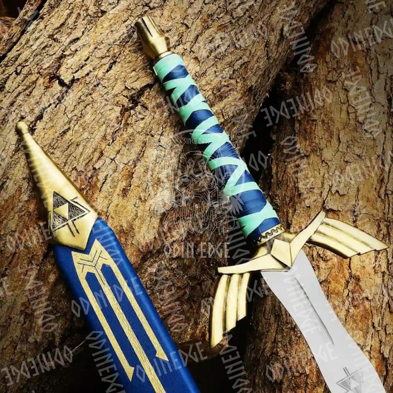 May include: A decorative sword with a gold hilt and blade, and a blue and green wrapped handle. The scabbard is blue with gold accents and a triangle emblem. The sword is displayed on a textured wooden surface.