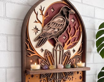 May include: A layered wooden wall art piece featuring a dark raven perched on a crystal cluster against a crescent moon and star background. The piece includes a small shelf holding two lit tea light candles and five polished gemstones.