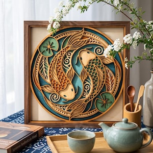 May include: A square wooden wall art piece featuring a multi-layered circular design of two koi fish swimming in a yin-yang formation. The fish are rendered in natural wood tones against a deep teal background, accented by green lily pads.