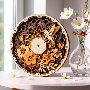 May include: A circular wooden wall clock featuring a layered mandala design with a hummingbird and floral motifs in shades of brown, tan, and orange. The clock face has a light wood center with Roman numerals along the outer rim.
