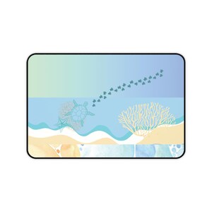 May include: A rectangular mousepad featuring an ocean scene with a sea turtle, starfish, and coral. The design includes a gradient sky, waves, and a sandy beach. Small sea turtles trail across the water.