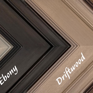 May include: A selection of wooden picture frames in various colors, including Graywash, Ebony, Driftwood, and Chestnut. Each frame has a beveled edge and is labeled with its color name in a cursive font.