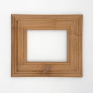 May include: A square wooden picture frame with a honey-colored finish. The frame has a layered design with a recessed inner edge and a smooth, light-colored interior. The word "Honey" is printed in the bottom left corner.