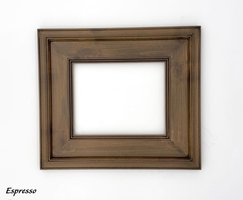 May include: A rectangular picture frame with a dark brown espresso finish. The frame has a layered design and a white interior. The word "Espresso" is printed in the bottom left corner.
