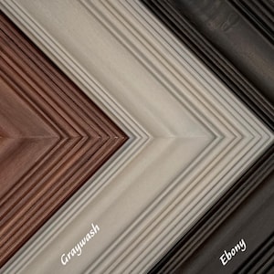 May include: Close-up of four wooden picture frame corners in a chevron pattern. The frames are Sangria, Graywash, and Ebony. Each frame has a grooved texture and the name of the color is printed on the frame in white.