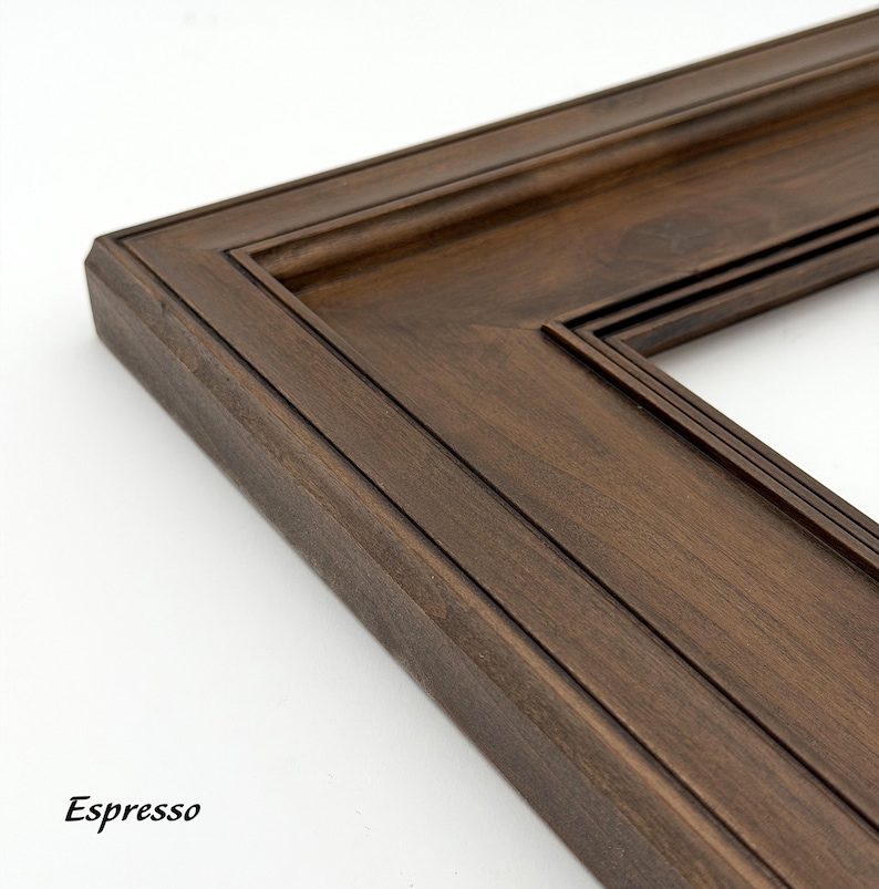May include: Close-up of a dark brown wooden picture frame with a layered design. The frame has a rich espresso finish and features the word "Espresso" in the bottom left corner.