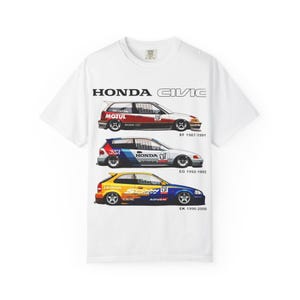 May include: White t-shirt featuring three Honda Civic race car illustrations. The cars are in red, blue, and yellow, with the text "HONDA CIVIC" above them. Each car has a different year range: EF 1987-1991, EG 1992-1995, and EK 1996-2000.