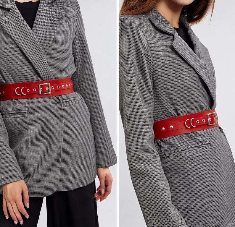 May include: A red leather belt with a silver buckle and rivets. The belt is worn over a gray and black houndstooth blazer. The belt is approximately 2 inches wide.