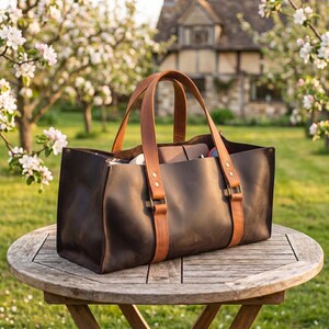 Close-up lifestyle photo of leather garden tool bag filled with pruners, hammer, brush and hand tools for daily use