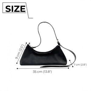 May include: Black shoulder bag with a curved design. The bag is 13.8 inches long, 3.5 inches high, and 2.8 inches wide. The image includes the word "SIZE".