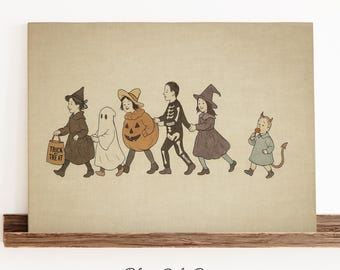 May include: A vintage-style print featuring children in Halloween costumes walking in a line. The costumes include a witch, ghost, pumpkin, skeleton, another witch, and a devil. The first child carries a bag that says "Trick or Treat".