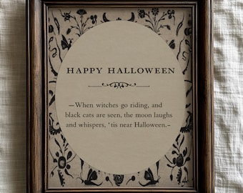 May include: A framed print with the text "HAPPY HALLOWEEN" in a circular design. The print includes a quote about witches and black cats, with floral and butterfly accents. The frame is dark brown.