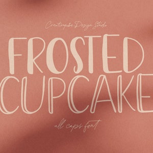 May include: A white font design with the text "FROSTED CUPCAKE" in a handwritten style. The text "all caps font" is also included below the main text.