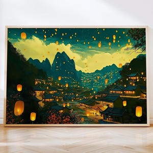 May include: A rectangular wall art print featuring a landscape painting of a village nestled between dark green mountains at night, illuminated by numerous glowing yellow lanterns floating in the sky and hanging from traditional buildings.