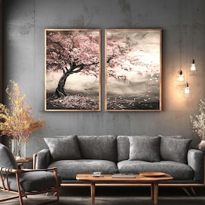 a living room with a gray sofa, a wooden coffee table, and two framed paintings of a tree with pink flowers hanging on the wall above the sofa.
