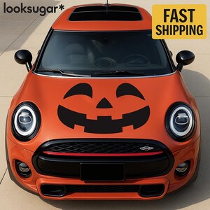 May include: An orange car with a black jack-o'-lantern face decal on the hood. The car has black accents, a red stripe, and the text "FAST SHIPPING" on a yellow rectangle.