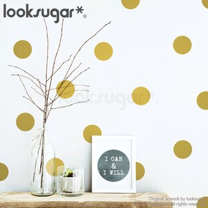 May include: White wall with gold polka dots, a framed print with the text "I CAN & I WILL", and decorative glass bottles with branches and a small plant on a wooden shelf. The looksugar* logo is in the top left corner.
