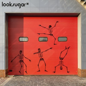 May include: A red garage door decorated with four black skeleton decals in dancing poses. The word "looksugar*" is in the upper left corner. The door has three small rectangular windows.