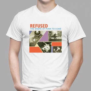 May include: White t-shirt with the band name "REFUSED" in red lettering above a graphic design. The design includes the text "THE SHAPE OF PUNK TO COME" and several black and white images with orange and purple geometric shapes.