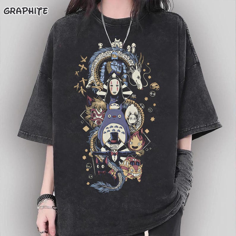 May include: Graphite-colored oversized t-shirt featuring a colorful graphic of anime characters. The design includes a dragon, Totoro, and other figures. The shirt has short sleeves and a relaxed fit, perfect for casual wear.
