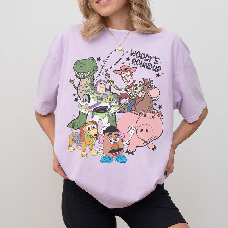 May include: A white ceramic mug with a black handle and the text "But First, Coffee" in a bold, black font. The mug is sitting on a wooden surface. The mug is approximately 4 inches tall.