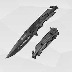 Puede incluir: Dos cuchillos plegables negros. El cuchillo más grande tiene una hoja puntiaguda y el texto "YOUR DESIGN HERE". El cuchillo más pequeño está cerrado, con un clip para el bolsillo y el mismo texto. Ambos cuchillos tienen un abridor de botellas.