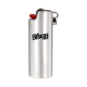 May include: A silver-colored lighter with a red button and a black text that says "YOUR DESIGN HERE". The lighter has a metal loop on the side.