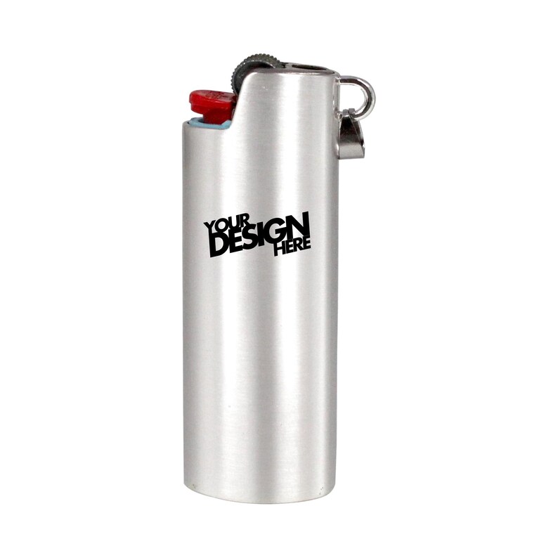 May include: A silver-colored lighter with a red button and a black text that says "YOUR DESIGN HERE". The lighter has a metal loop on the side.