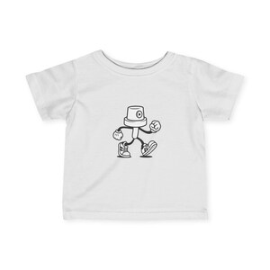 May include: White baby t-shirt featuring a black and white cartoon illustration of a walking spray paint nozzle character. The character has a round head with an eye, arms, legs, and sneakers. The design is centered on the front of the shirt.