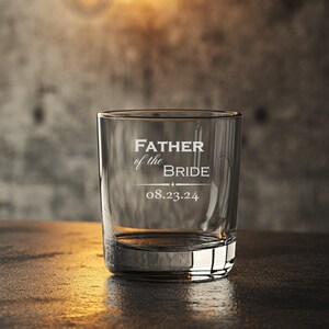 May include: A clear glass tumbler with the text "Father of the Bride" and the date "08.23.24" etched on the front.