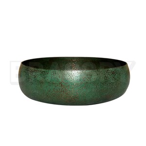 May include: A large, round, green metal bowl with a hammered finish. The bowl has a distressed look with a copper patina.