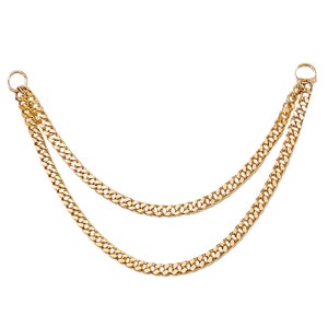 May include: A gold chain necklace with two strands of linked curb chains.