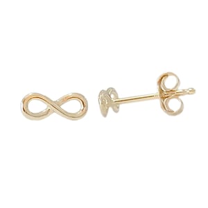 May include: A pair of gold infinity symbol earrings. The earrings are small and delicate, and they are perfect for everyday wear.