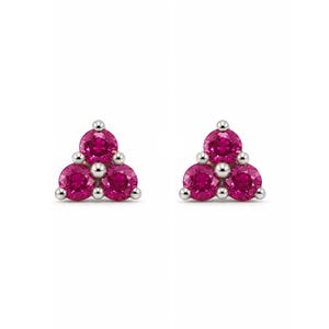 May include: A pair of stud earrings featuring three round-cut, vibrant pink stones arranged in a triangular cluster. Each stone is held in place by a polished silver-toned metal setting, creating a symmetrical and cohesive design for each earring.