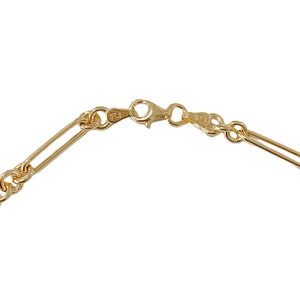 May include: A gold chain necklace with a lobster clasp fastening. The chain is made of a thick, rope-like design.