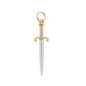 May include: A gold and silver dagger charm with a clear gemstone set in the handle.