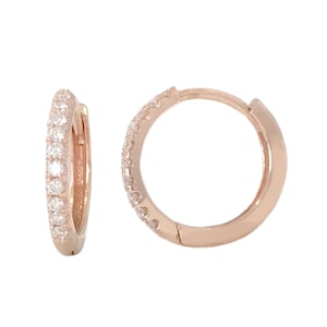 May include: A pair of rose gold hoop earrings with a single row of small clear diamonds around the edge.