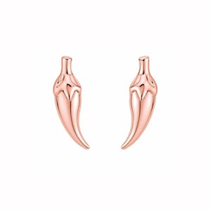 May include: A pair of rose gold chili pepper stud earrings. The earrings are shaped like stylized chili peppers, with a smooth, polished finish. The peppers have a curved shape and a detailed top.