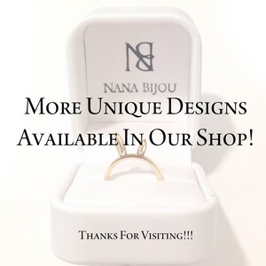 May include: A gold-toned ring featuring two small upright ears, presented in a white jewellery box. The box lid displays the text NANA BIJOU, while the centre text reads MORE UNIQUE DESIGNS AVAILABLE IN OUR SHOP! and the bottom reads THANKS FOR VISITING!!!