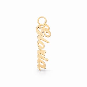 May include: A gold-coloured pendant in the shape of the name "Gloria" in a cursive script. The pendant has a small loop at the top for attaching to a chain. The background is plain white.