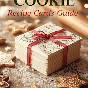 May include: A stack of recipe cards tied with a red ribbon, surrounded by star-shaped gingerbread cookies dusted with powdered sugar. The cards have a festive design and the text "HOLIDAY COOKIE Recipe Cards' Guide" is at the top.