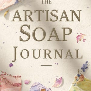May include: The Artisan Soap Journal cover features the title in a gold serif font. The image showcases various artisan soaps in pastel colors, adorned with lavender sprigs and petals. The background is a textured, off-white surface.