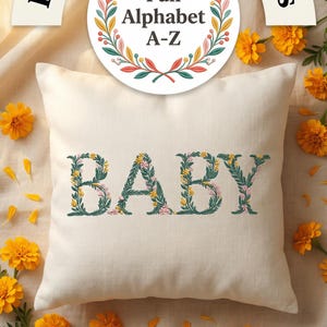 Floral embroidery font mockup on cream linen pillow surrounded by golden marigold flowers. Word BABY embroidered in botanical teal green letters with yellow and pink blooms. Curved arch title and colorful Full Alphabet A-Z wreath badge. Commercial use OK. 26 letters, 6 sizes 3.5 to 6 inch, 10 formats. PES DST JEF XXX VP3 VIP HUS EXP ART SEW.
